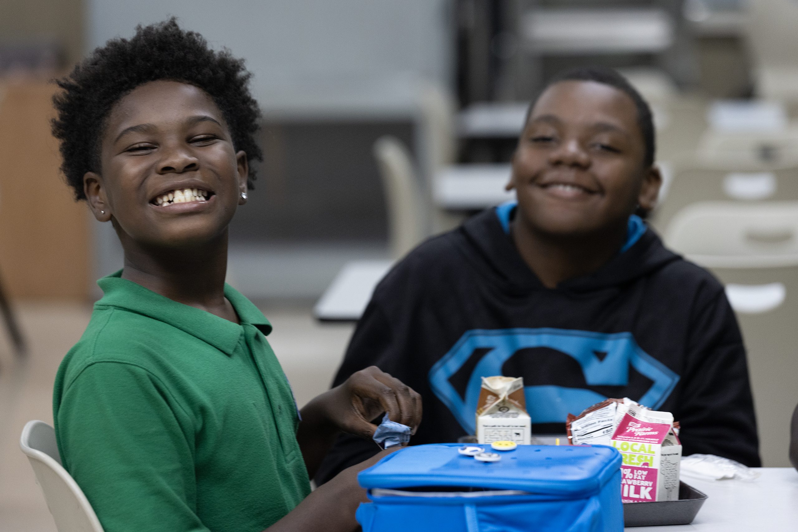 compass frayser students lunch Two Compass Frayser students laughing together at lunch