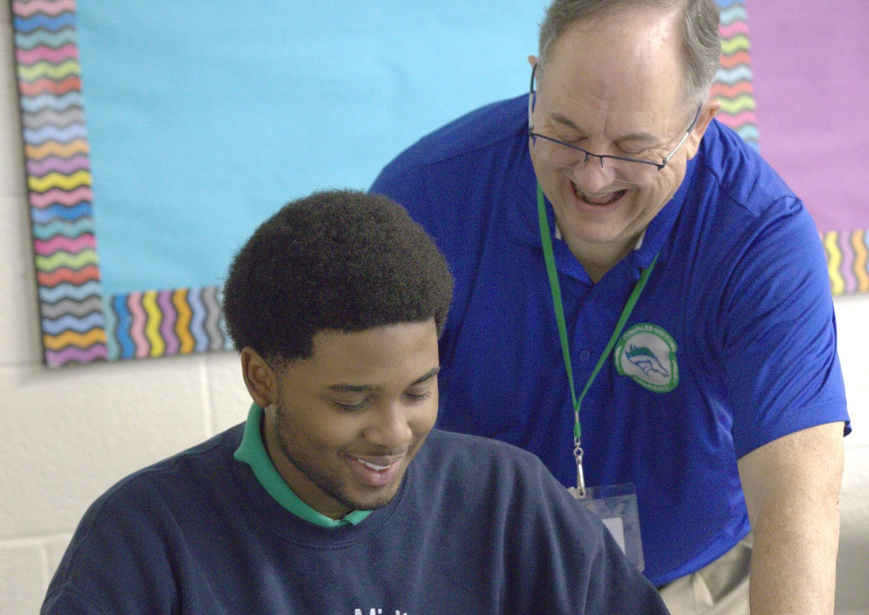 Compass teacher coaching a student in class